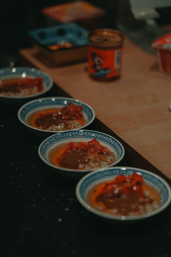 A set of flavorful Chinese sauces arranged in traditional bowls, embodying culinary art.